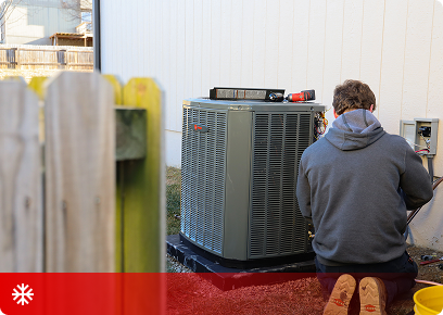 KB Complete technician kneeling in front of an outdoor air conditioning condenser