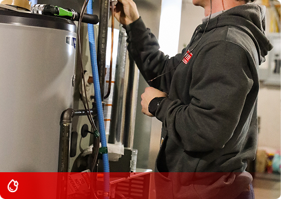 KB Complete technician working on the top connections of a water heater