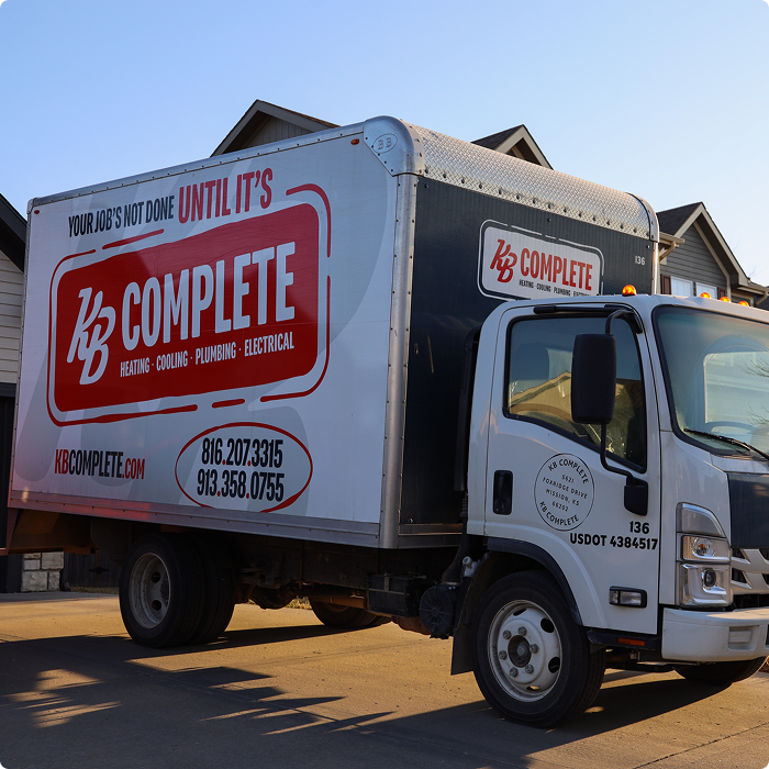 KB Complete box truck driving through a residential neighborhood in the service area
