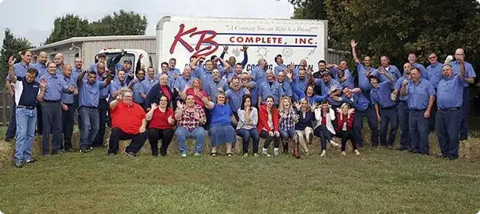 The KB Complete team gathered for a group photo in front of a company box truck